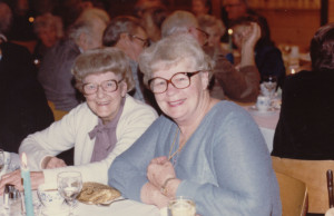 Evelyn Paton and Lulu Renwick sit together at a table at the Legion Christmas Party. ca. 1980