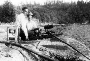: Fred Taylor and Joe Inneichen operating a water pump while fighting a fire at Tunstall Bay. ca. 1940’s